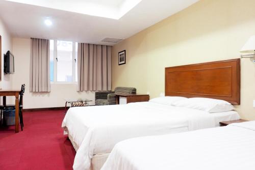 Katil atau katil-katil dalam bilik di Cottage Inn Subang