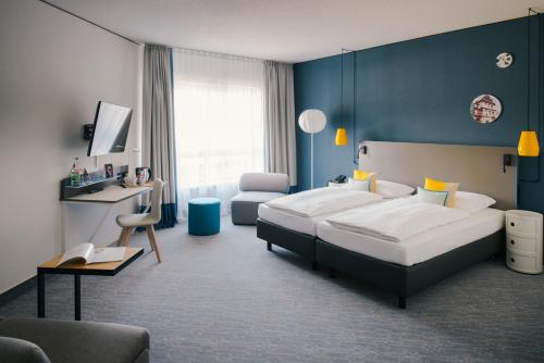 Postel nebo postele na pokoji v ubytování Vienna House Easy by Wyndham Coburg