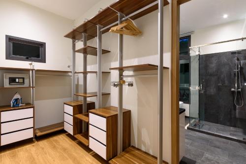 a room with a shower and a walk in closet at Inspire Villas Phuket in Rawai Beach