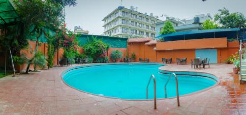 a swimming pool in the middle of a courtyard at Hotel Vaishali in Kathmandu
