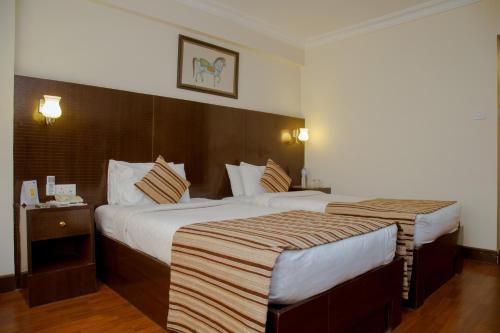 a hotel room with two beds in a room at Hotel Vaishali in Kathmandu