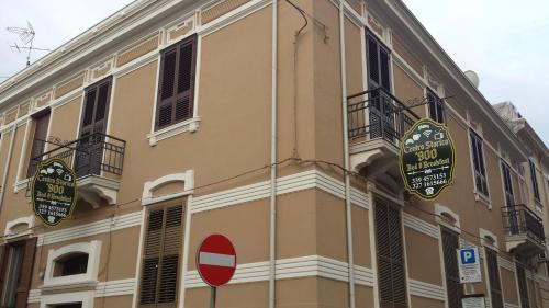 a building with signs on the side of it at B&B Centro Storico 900 in Palmi