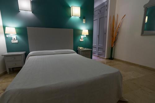 Postel nebo postele na pokoji v ubytování Hostal Drago