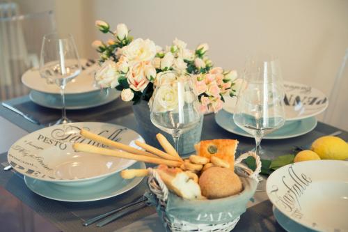 a table with plates and bowls of food and flowers at la Senesina in Monteriggioni