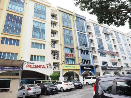 a large building with cars parked in front of it at Sun Inns Hotel Subang in Subang Jaya