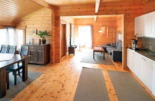 a kitchen and living room in a log cabin at Mökki Lahtela in Puumala