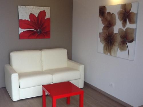 a living room with a white couch and a red table at Agriturismo Dell'Orto Apartments in Verona