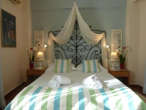 a bedroom with a large bed with towels on it at Calergi Residence - Holidays in Crete in Atsipopoulo