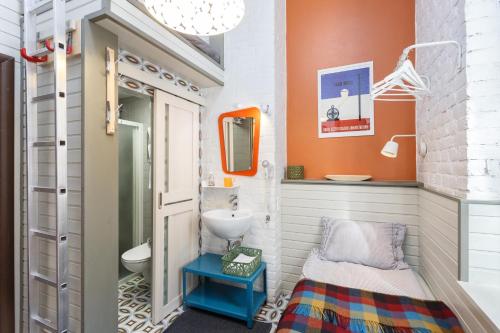 a small bathroom with a sink and a toilet at Mogol Apartments in Saint Petersburg