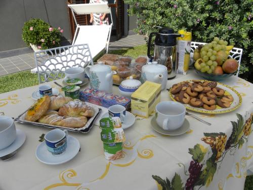 a table with pastries and other food on it at Poggio Sambuco in Viagrande