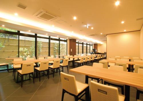 a classroom with tables and chairs and a chalkboard at AB Hotel Kyoto Shijo Horikawa in Kyoto