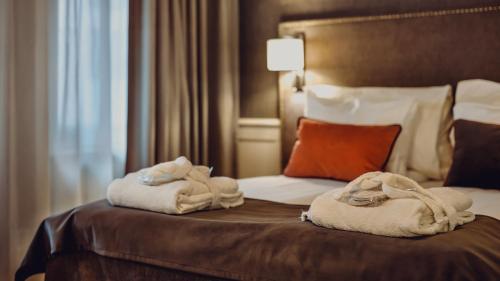 a hotel room with a bed with towels on it at Home Hotel Grand Bodø in Bodø