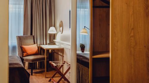 a hotel room with a chair and a desk at Home Hotel Grand Bodø in Bodø
