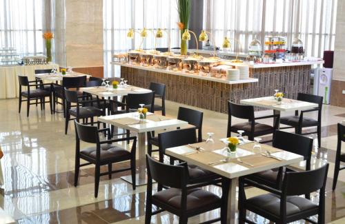 a dining room with tables and chairs in a restaurant at One Central Hotel & Suites in Cebu City
