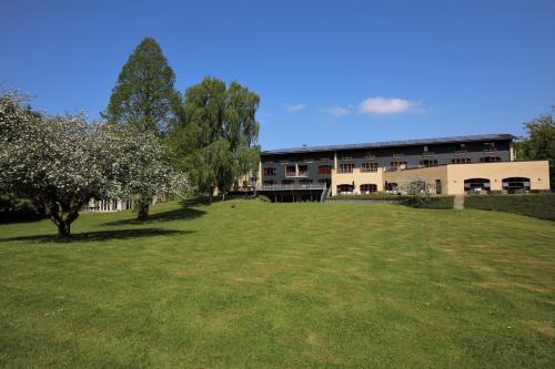 a building with a large yard in front of it at Hotel Amerika in Hobro