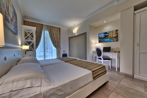 Ένα ή περισσότερα κρεβάτια σε δωμάτιο στο Hotel Excelsior Le Terrazze