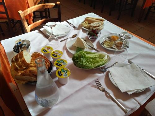 a table with plates of food and a bottle of milk at B&B Supramonte in Orgosolo