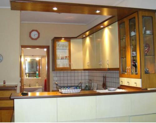 a kitchen with wooden cabinets and a counter top at Lovely house with garden at an excellent location! in Agria