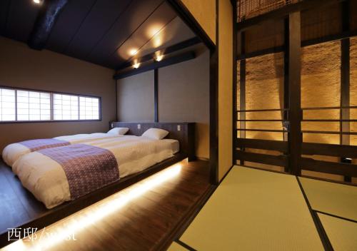 a bedroom with a large bed and a window at Houka in Kyoto