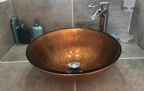 a wooden bowl sink in a bathroom with at Les Ecrins d'Aix-en-Provence in Aix-en-Provence