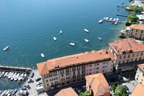 an aerial view of boats in the water near buildings at Hotel Bellavista in Menaggio