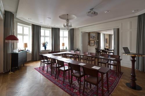 a dining room with a long table and chairs at Hotel Kung Carl, WorldHotels Crafted in Stockholm