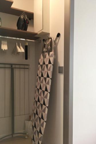 a black and white umbrella hanging from a wall at ComeWa Apartments in Warsaw