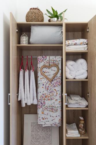 a closet with a heart towel and towels at Sweet Home Kremasti in Kremasti