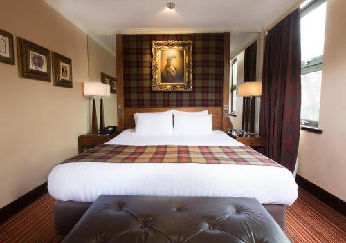 a hotel room with a bed and a picture on the wall at The Queen at Chester Hotel, BW Premier Collection in Chester