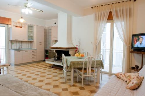 a kitchen and dining room with a table and a fireplace at B&B Nova Siri in Nova Siri Marina