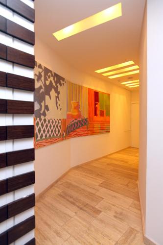 an empty room with paintings on the wall at Centrum Hotel - City Center in Nicosia