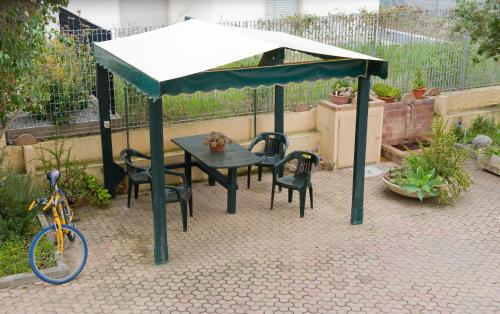 a gazebo with a table and chairs and a bike at B&B Nova Siri in Nova Siri Marina