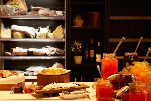 a table with food and drinks in a refrigerator at Nido, Mar-Bella Collection in Agios Ioannis Peristeron