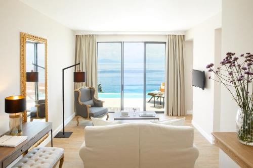 a living room with a view of the ocean at Nido, Mar-Bella Collection in Agios Ioannis Peristeron
