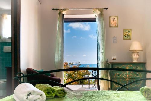 a bedroom with a window with a view of the ocean at B&B Mariposa in Maratea