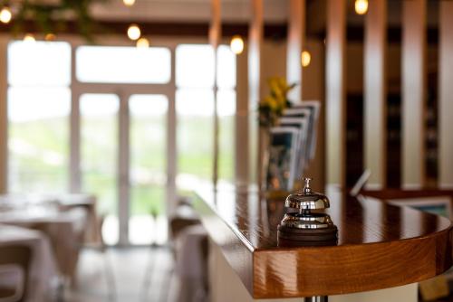 a table in a restaurant with a bell on it at Il Podere di Marfisa in Farnese