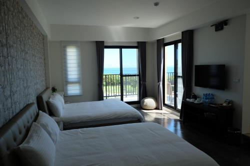 Ένα ή περισσότερα κρεβάτια σε δωμάτιο στο Moonlit Seaview Homestay