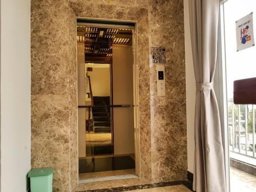 a bathroom with a mirror in a room at Tropical House in Ho Chi Minh City