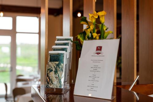 a vase of flowers sitting next to books on a table at Il Podere di Marfisa in Farnese