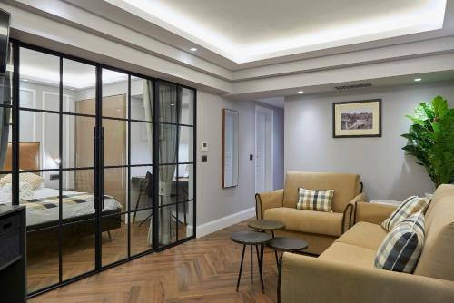 a living room with a couch and a bed at Marble House in Athens