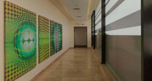 a hallway with paintings on the walls of a building at Hotel Sewa Grand Faridabad in Faridabad
