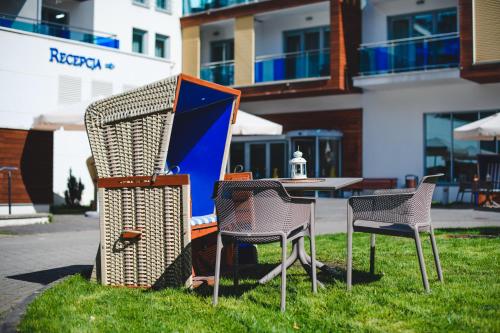 a group of chairs and a table in the grass at Best Western Hotel Jurata in Jurata