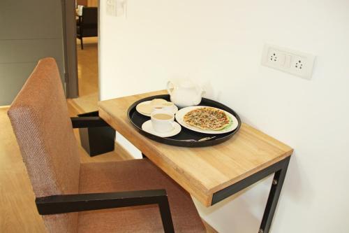 a table with a plate of food on top of it at FabHotel Tanvi Grand in Visakhapatnam