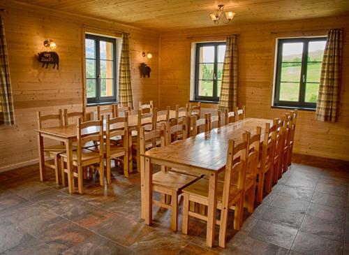 a dining room with a wooden table and chairs at Belianska Chata in Ždiar