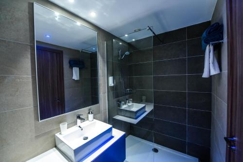 a bathroom with a sink and a mirror at Eleana Hotel in Ayia Napa