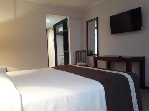 Ein Bett oder Betten in einem Zimmer der Unterkunft Hotel El Araucano