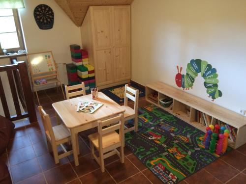 a dining room with a table and a table and chairs at Penzion Terezka in Králíky
