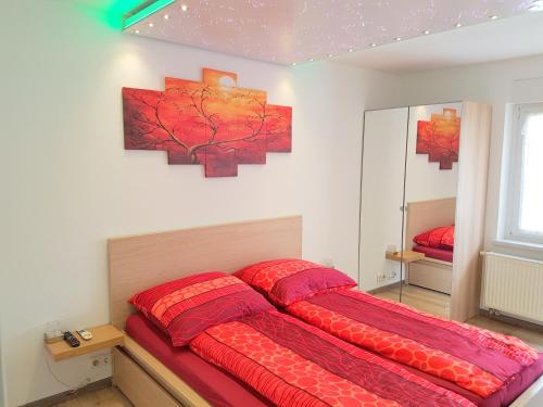 ニュルンベルクにあるApartment Reginaのベッドルーム1室(大型ベッド1台、赤い掛け布団付)