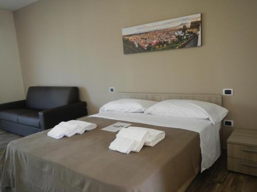 a hotel room with a bed with towels on it at Zia Bi Bed and Breakfast in Naples