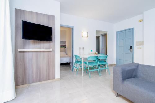 a living room with a couch and a table at Apartamentos Lago in Colònia de Sant Jordi